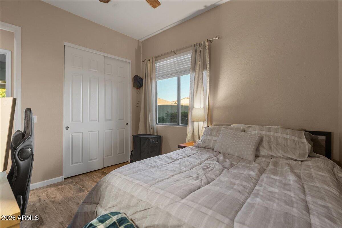 6427 South Magic Court Gilbert, AZ 85298 - Photo 39 of 71 a bedroom with a bed a mirror and a window