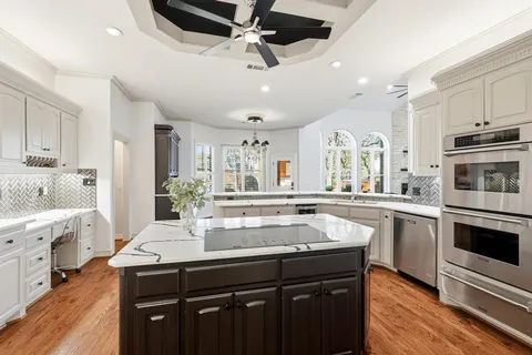 a kitchen with stainless steel appliances granite countertop a sink and stove