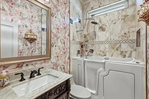 a bathroom with a sink toilet and shower