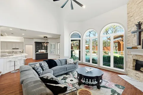 a living room with furniture chandelier and a fireplace