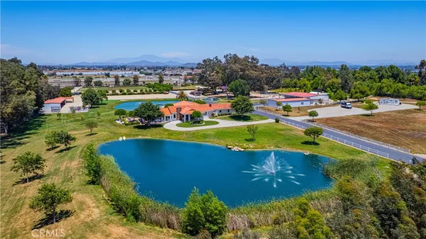 an aerial view of a house with a swimming pool yard and outdoor seating