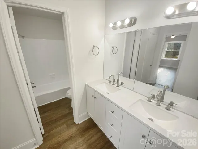 a white toilet sitting next to a bath tub