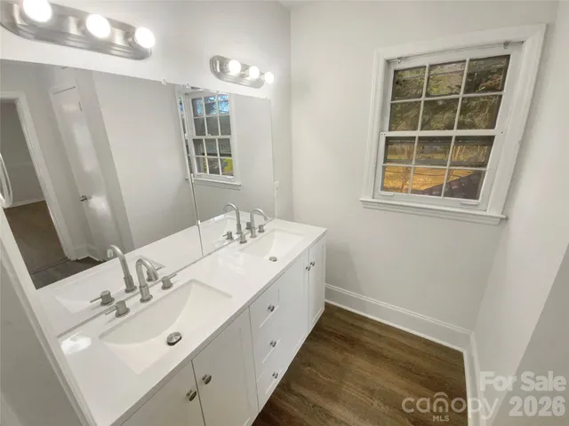 a bathroom with a sink toilet and a window