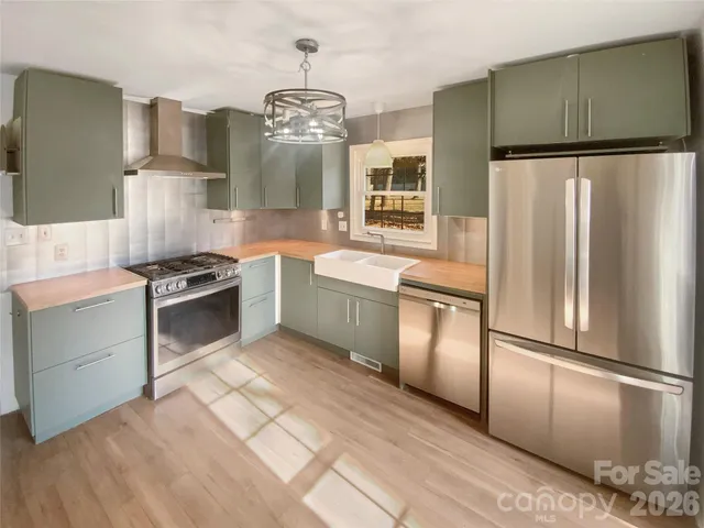 a spacious bathroom with a double vanity sink a mirror and a bathtub