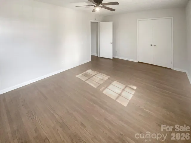 a view of a livingroom with furniture and an empty room