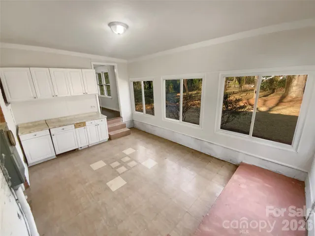 a view of a livingroom with furniture and a window