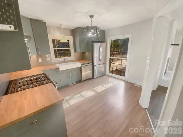 a kitchen with a refrigerator and a stove