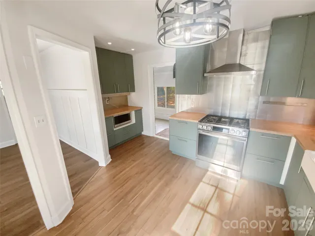 a view of a livingroom with a fireplace and a chandelier fan