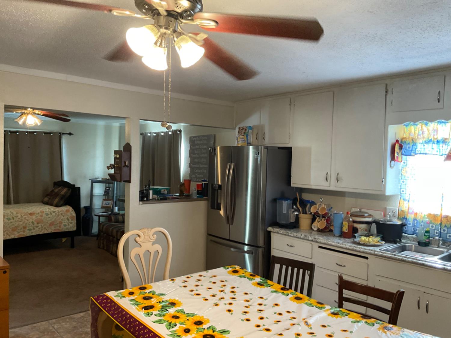 915 R Street Merced, CA 95341 - Photo 26 of 44 a kitchen with stainless steel appliances granite countertop a refrigerator a stove a sink dishwasher and white cabinets with wooden floor