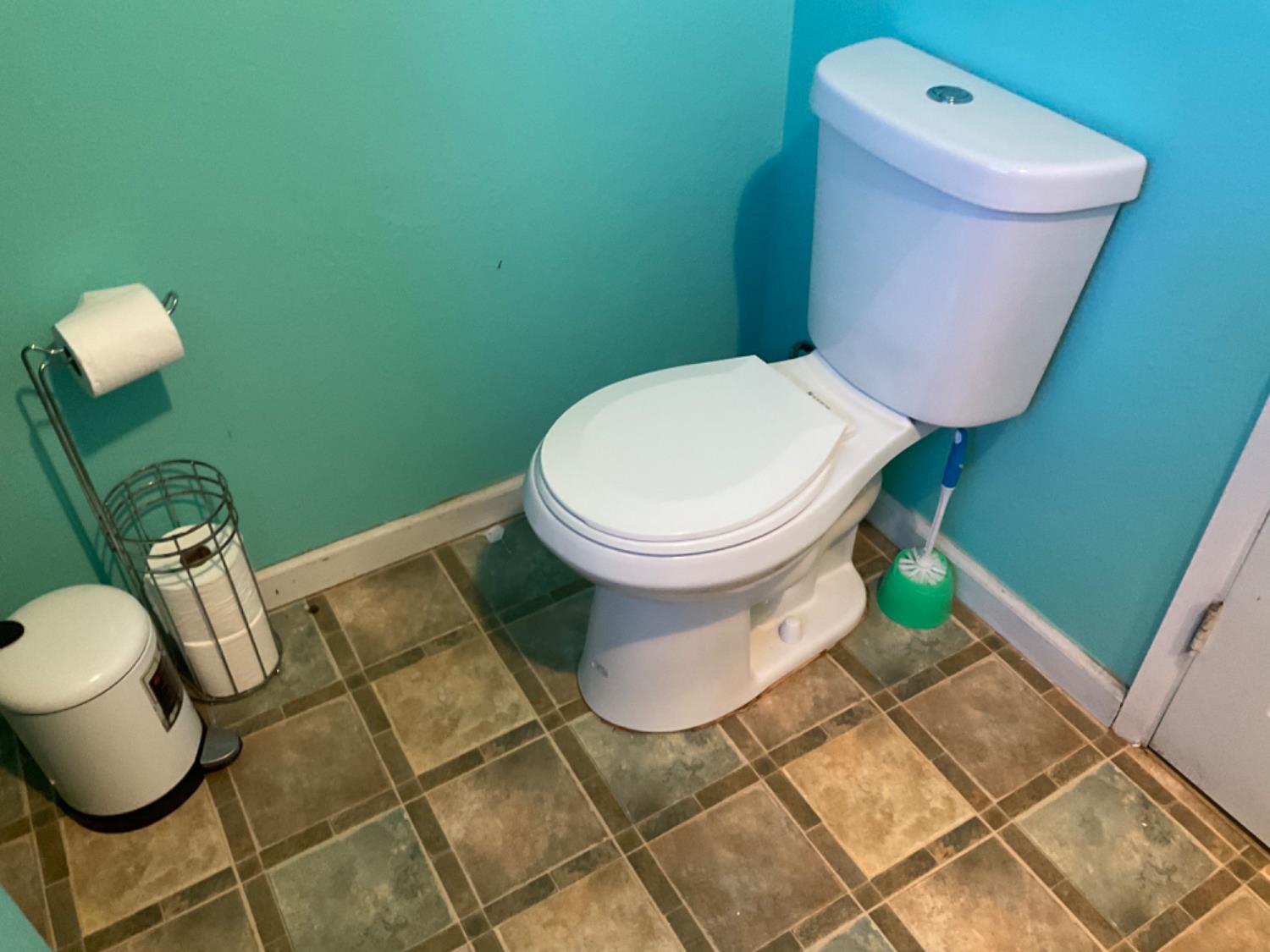 915 R Street Merced, CA 95341 - Photo 32 of 44 a white toilet sitting next to a shower