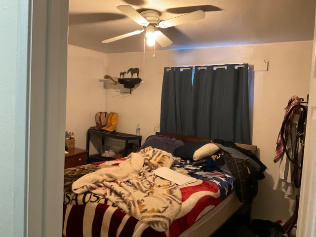 a bedroom with two beds and a chandelier