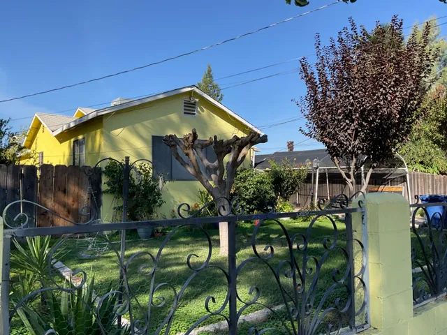 a view of a house with a tree in a yard