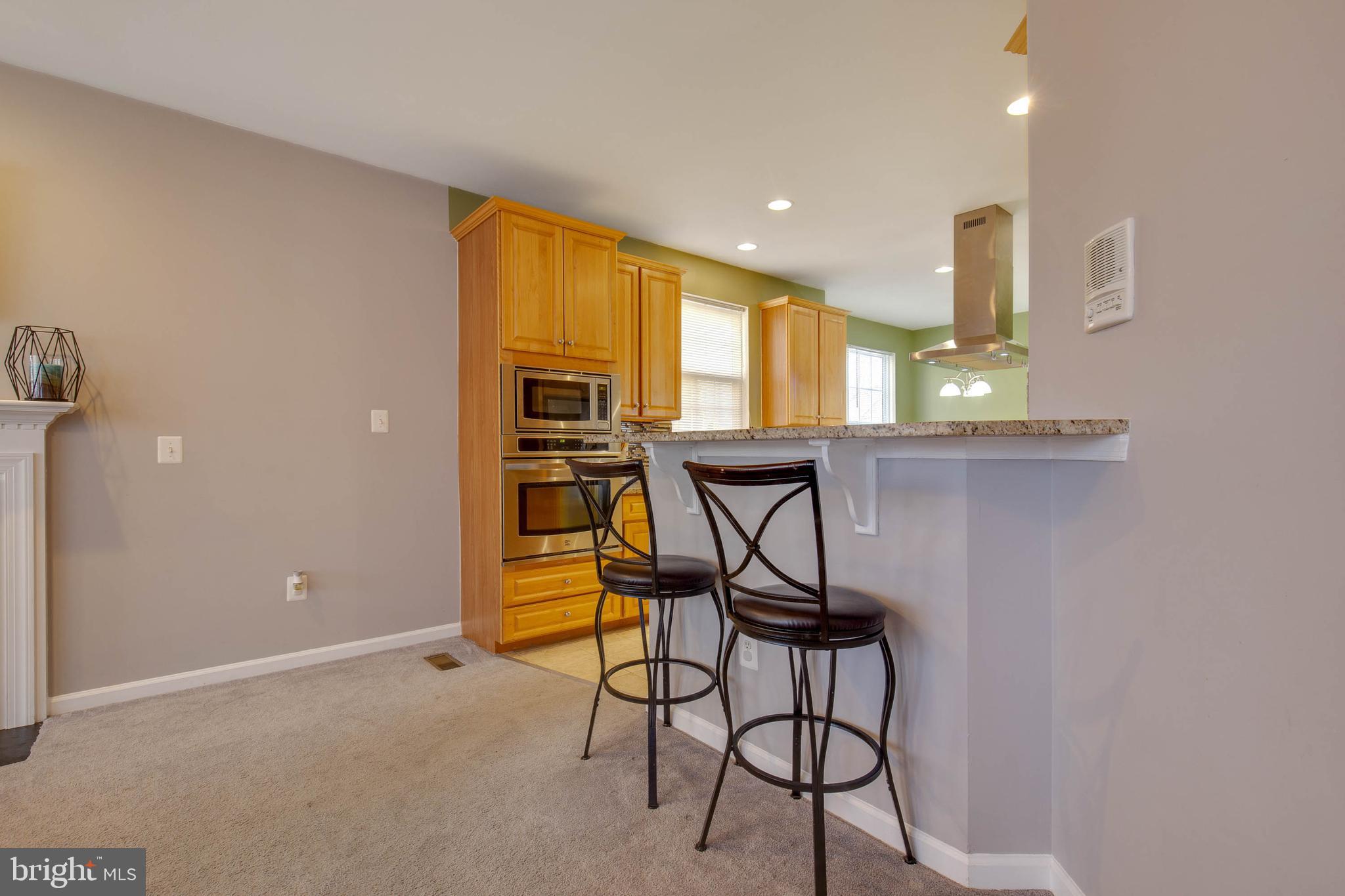 8371 Tillett Loop Manassas, VA 20110 - Photo 15 of 35 Bar Area Connecting Family Room & Kitchen