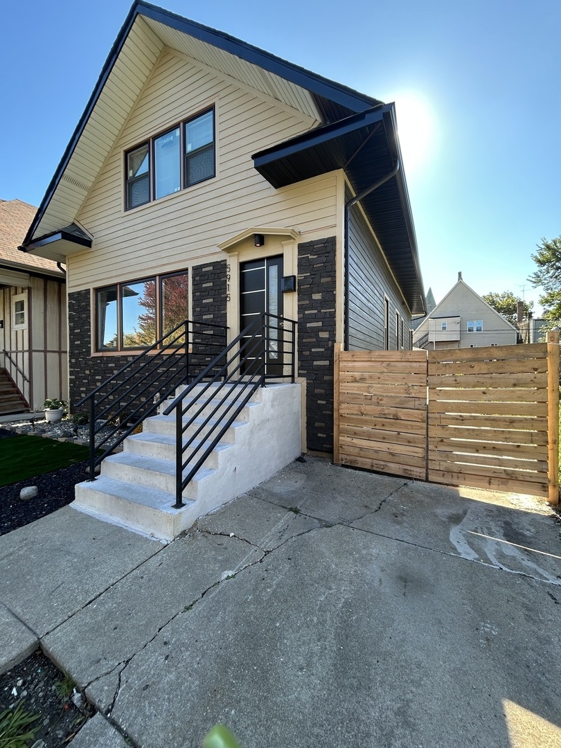 5915 West Iowa Street Chicago, IL 60651 - Photo 1 of 35 a view of a house with a yard