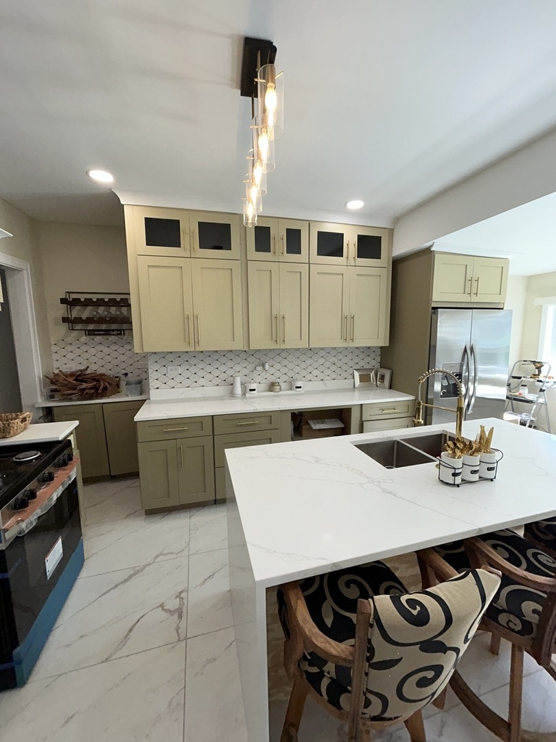 5915 West Iowa Street Chicago, IL 60651 - Photo 12 of 35 a kitchen with a stove a sink and a refrigerator