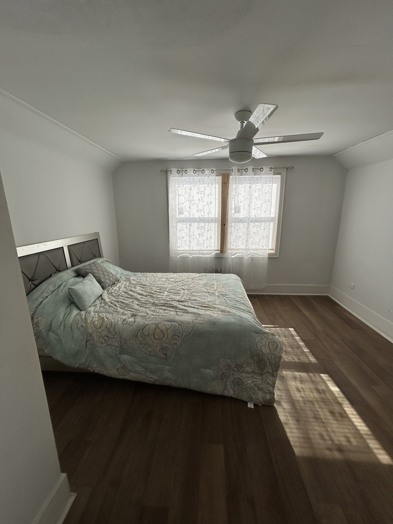 5915 West Iowa Street Chicago, IL 60651 - Photo 13 of 35 a bedroom with a bed and window