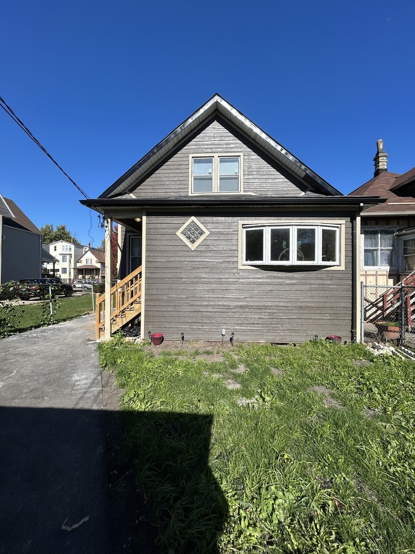 5915 West Iowa Street Chicago, IL 60651 - Photo 16 of 35 a front view of a house with garden