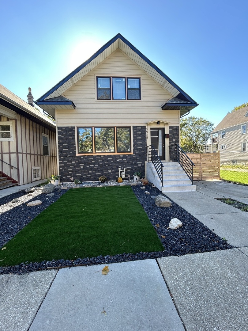 5915 West Iowa Street Chicago, IL 60651 - Photo 2 of 35 a front view of a house with garden