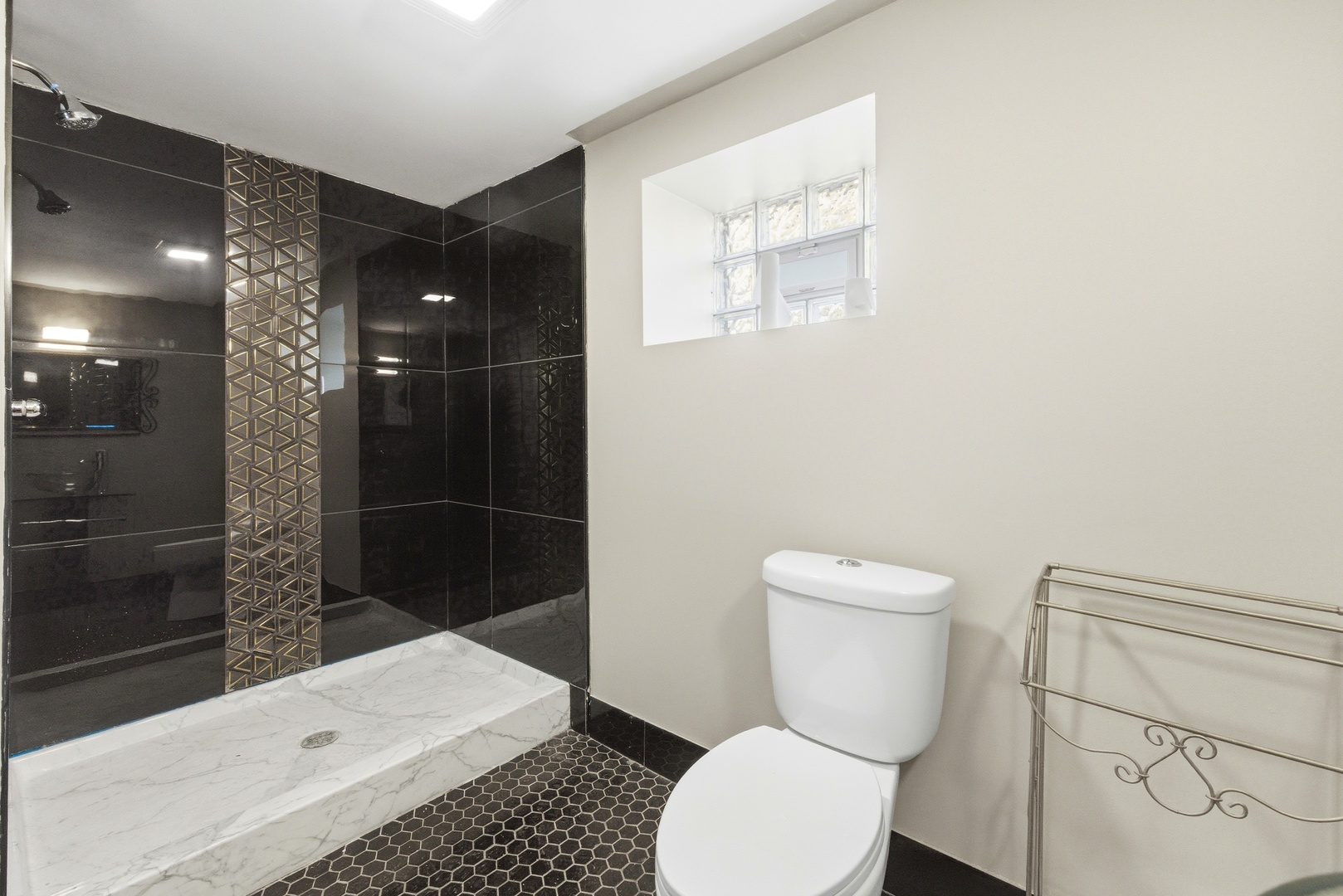 5915 West Iowa Street Chicago, IL 60651 - Photo 21 of 35 a bathroom with a toilet a sink and shower