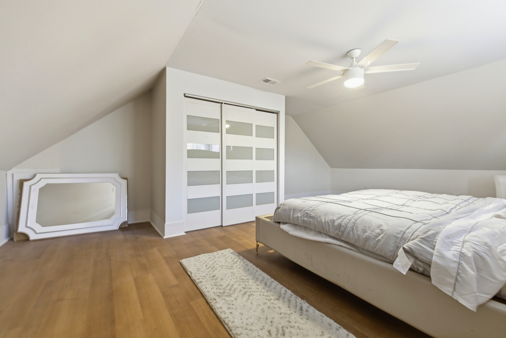 5915 West Iowa Street Chicago, IL 60651 - Photo 35 of 35 a bedroom with a bed and a mirror