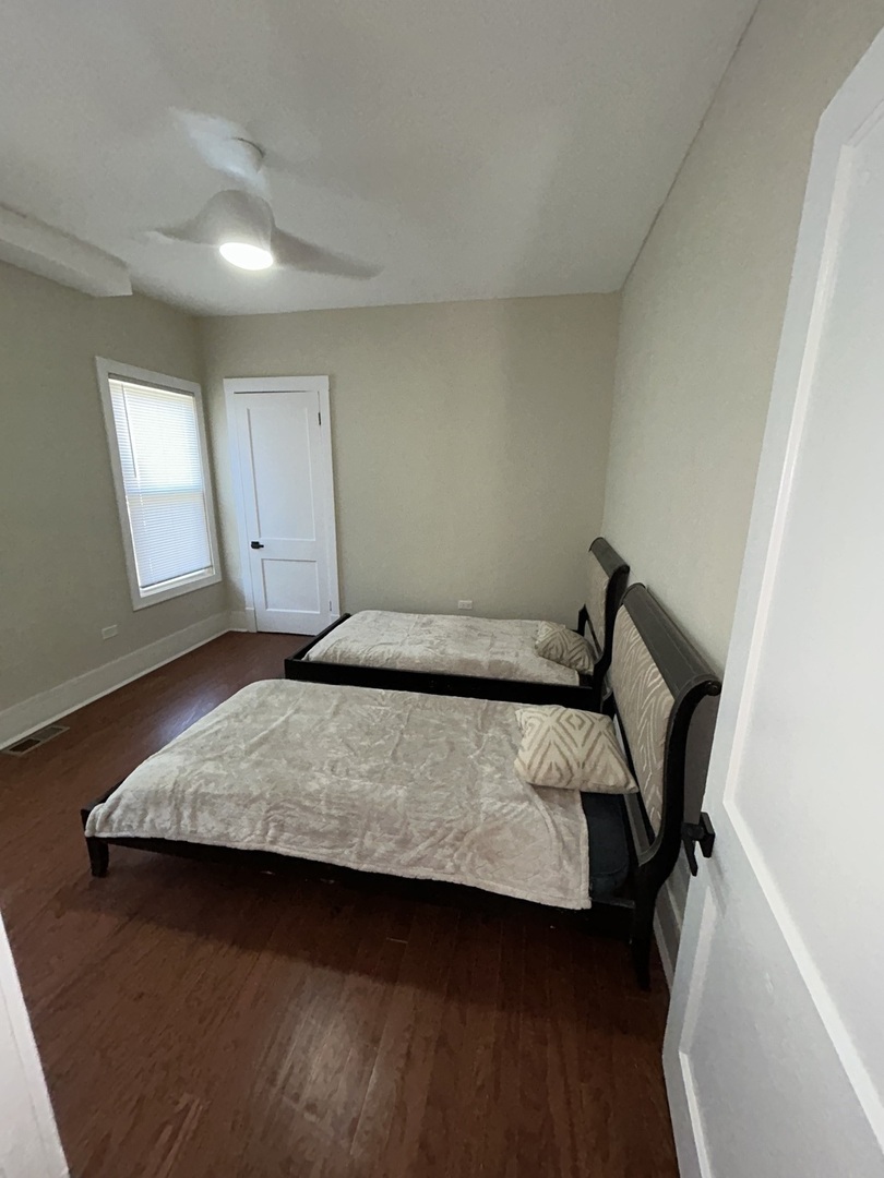 5915 West Iowa Street Chicago, IL 60651 - Photo 9 of 35 a bedroom with a bed and window