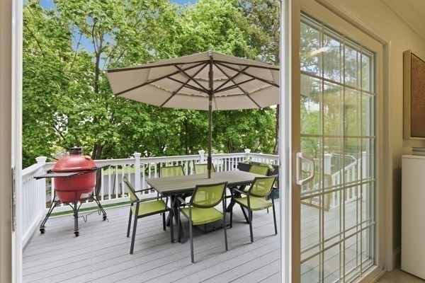 3 Wing Road Wilmington, MA 01887 - Photo 29 of 36 a table and chairs with the umbrella in the balcony