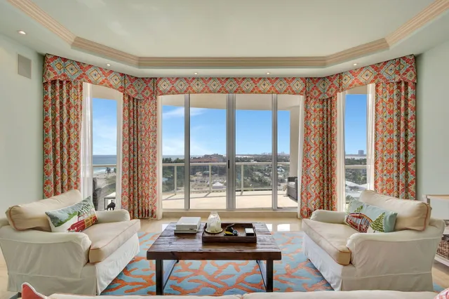 a living room with furniture and a chandelier