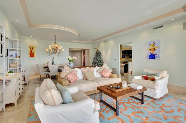 a living room with furniture and a baby crib