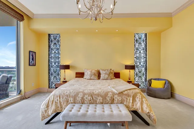 a spacious bedroom with a bed and a chandelier