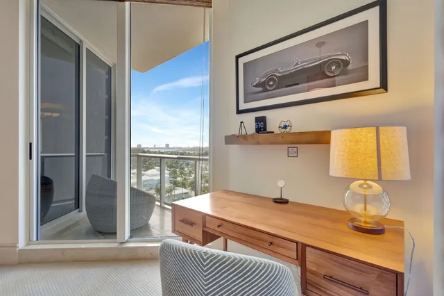 a bathroom with a granite countertop sink mirror vanity and toilet
