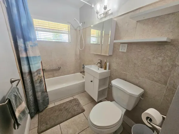 a white toilet sitting next to a bath tub