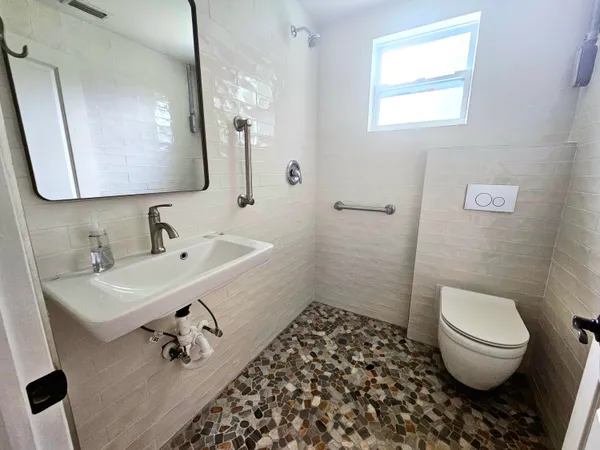 a bathroom with a sink toilet a mirror and vanity