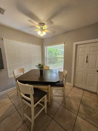 a view of a dining room with furniture and chandelier