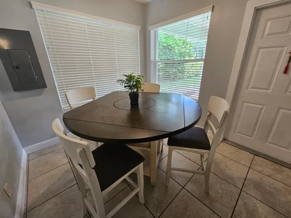 a view of a dining room with furniture and wooden floor