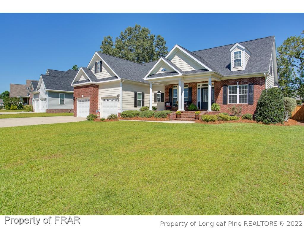1517 Epic Way Hope Mills, NC 28348 - Photo 2 of 36 a front view of a house with a yard table and chairs