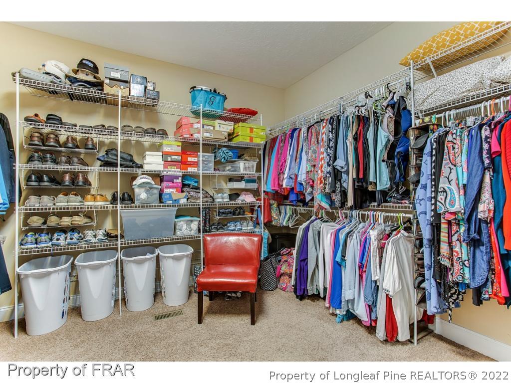 1517 Epic Way Hope Mills, NC 28348 - Photo 23 of 36 a view of walk in closet with clothes and shoes