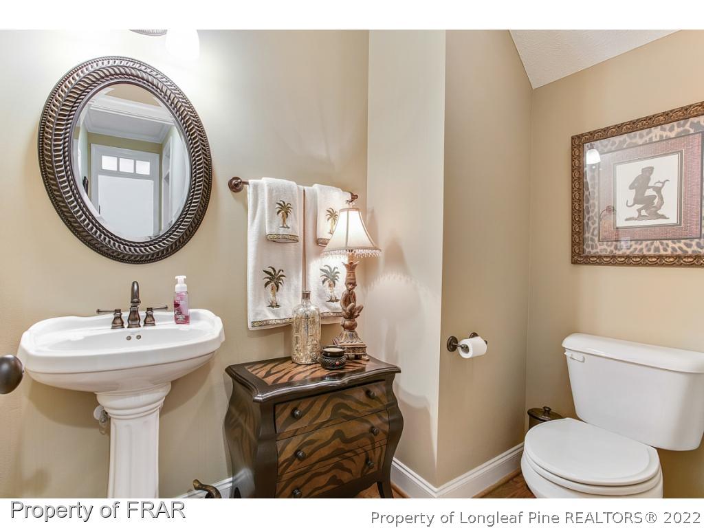 1517 Epic Way Hope Mills, NC 28348 - Photo 24 of 36 a bathroom with a sink mirror toilet and a mirror