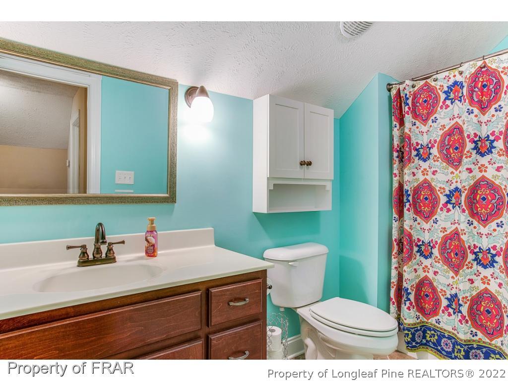 1517 Epic Way Hope Mills, NC 28348 - Photo 27 of 36 a bathroom with a toilet sink and mirror