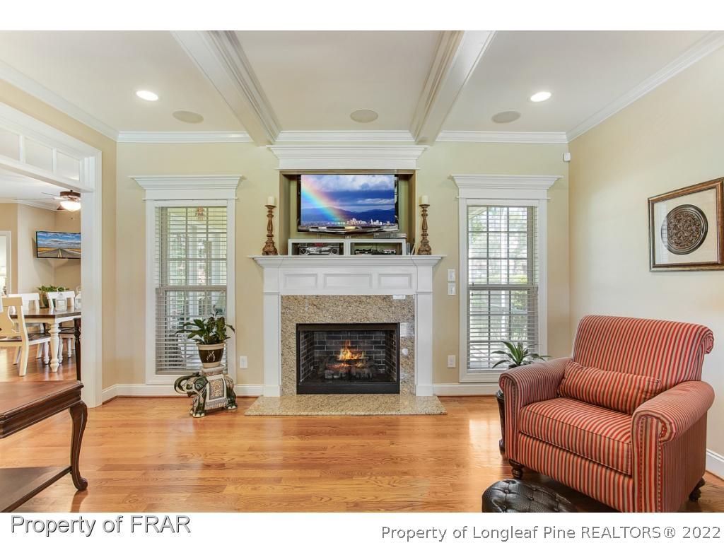 1517 Epic Way Hope Mills, NC 28348 - Photo 7 of 36 a living room with furniture a flat screen tv and a fireplace