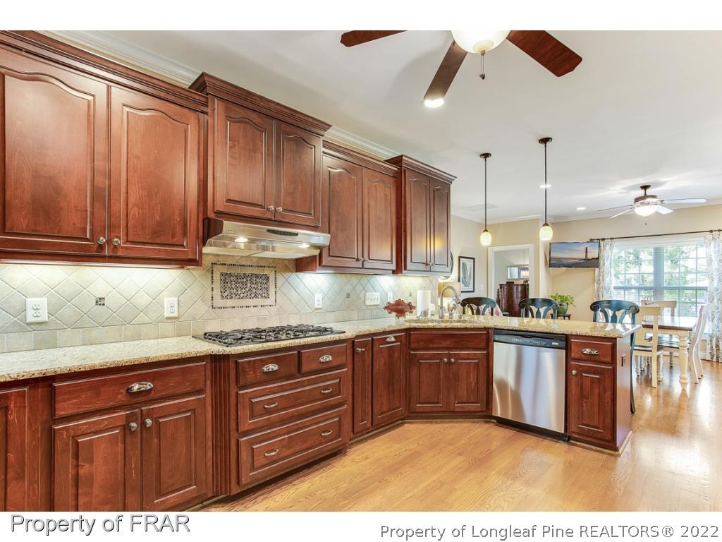 1517 Epic Way Hope Mills, NC 28348 - Photo 10 of 36 a kitchen with stainless steel appliances granite countertop a sink and cabinets