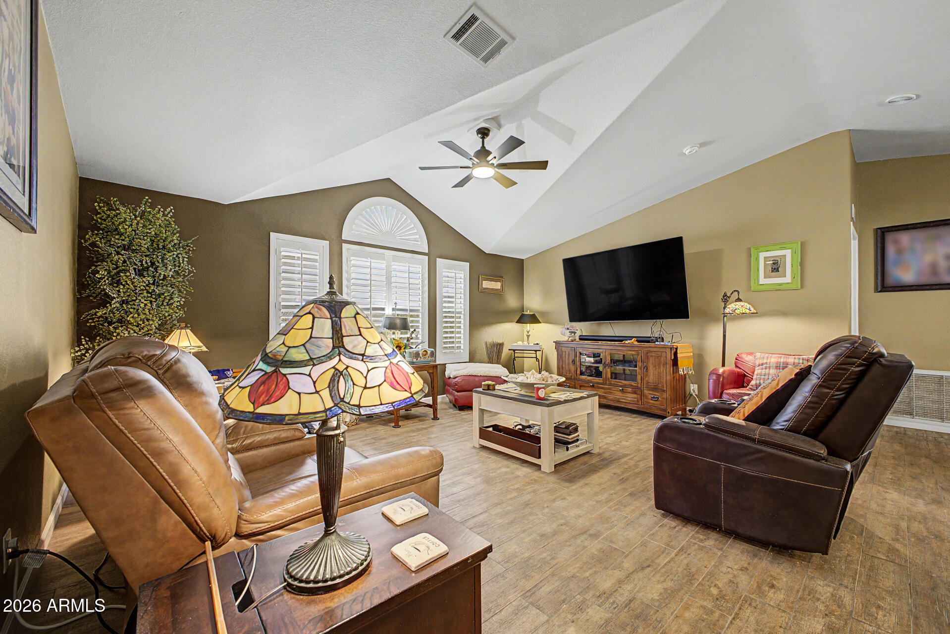2550 South Ellsworth Road, Unit 611 Mesa, AZ 85209 - Photo 12 of 34 a living room with furniture a flat screen tv and a chandelier