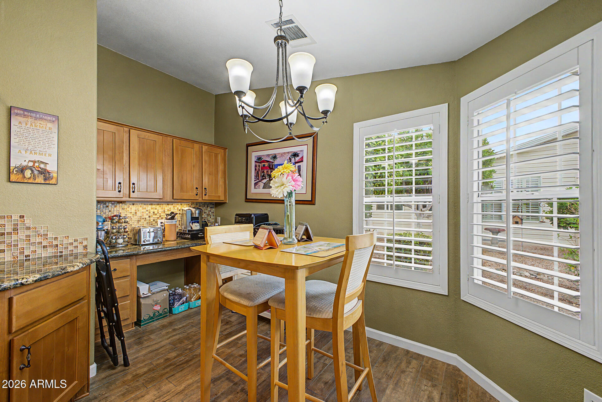 2550 South Ellsworth Road, Unit 611 Mesa, AZ 85209 - Photo 17 of 34 a view of a dining room with furniture window and wooden floor
