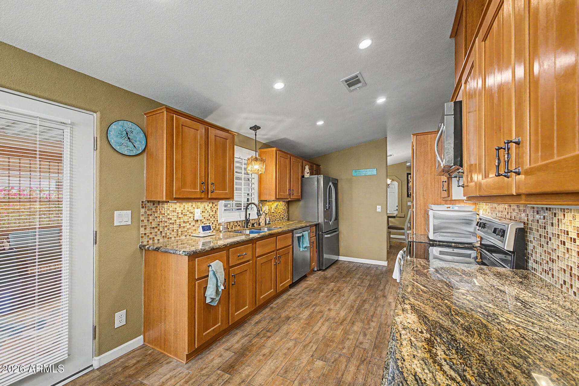 2550 South Ellsworth Road, Unit 611 Mesa, AZ 85209 - Photo 19 of 34 a kitchen with stainless steel appliances granite countertop a sink and cabinets