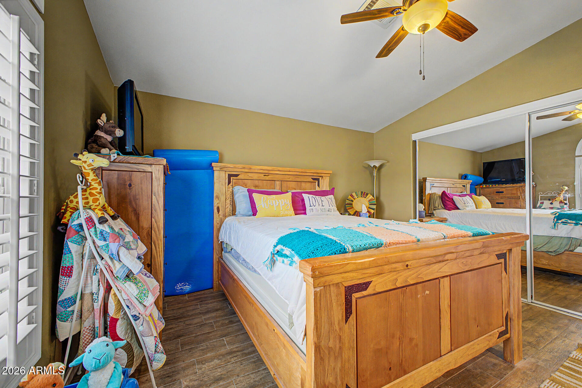 2550 South Ellsworth Road, Unit 611 Mesa, AZ 85209 - Photo 22 of 34 a bedroom with bed and a chandelier