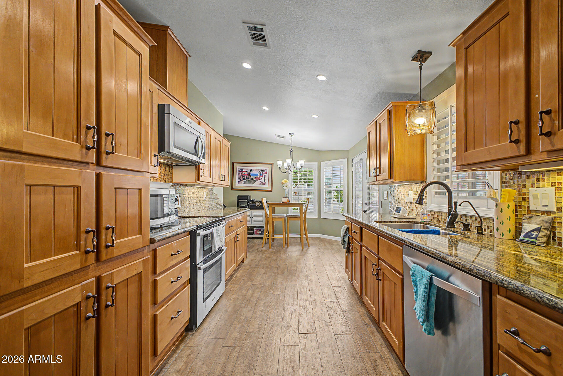 2550 South Ellsworth Road, Unit 611 Mesa, AZ 85209 - Photo 6 of 34 a kitchen with stainless steel appliances granite countertop sink stove and cabinets