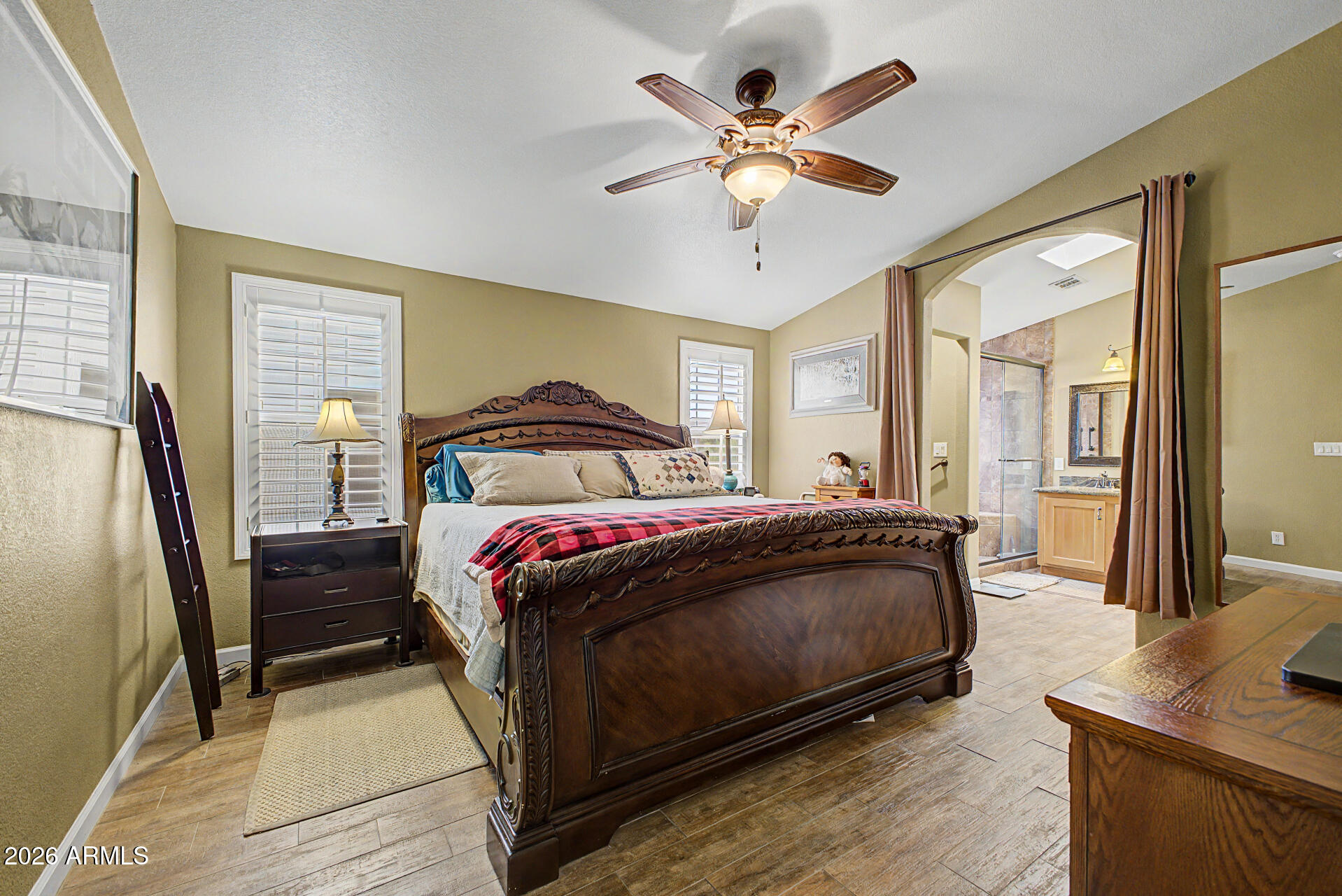 2550 South Ellsworth Road, Unit 611 Mesa, AZ 85209 - Photo 7 of 34 a bedroom with a large bed and a chandelier
