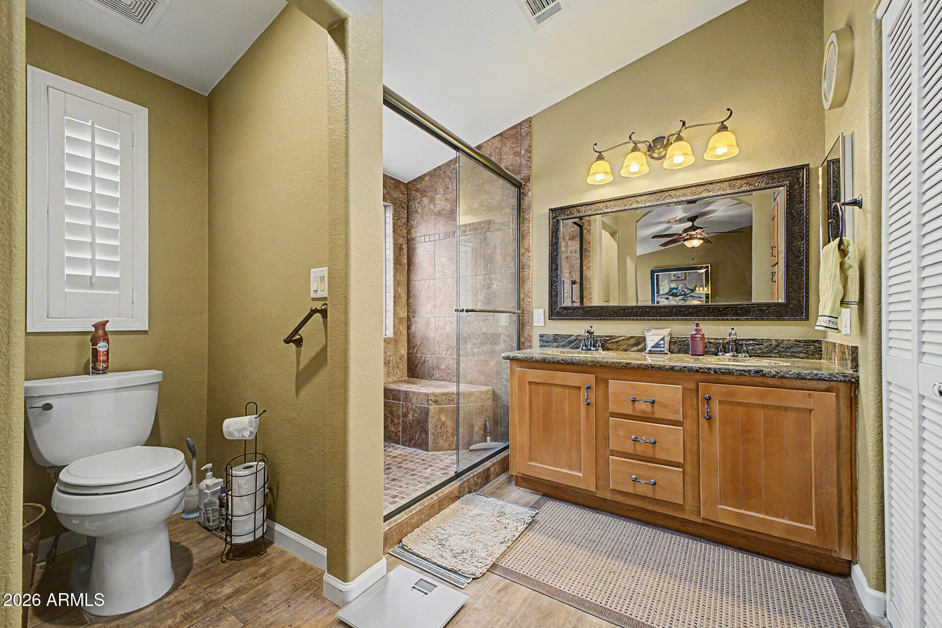 2550 South Ellsworth Road, Unit 611 Mesa, AZ 85209 - Photo 8 of 34 a bathroom with a toilet sink and mirror
