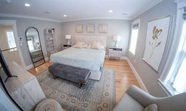 a bedroom with furniture and wooden floor