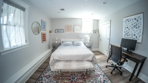 a bathroom with a granite countertop sink mirror vanity and toilet