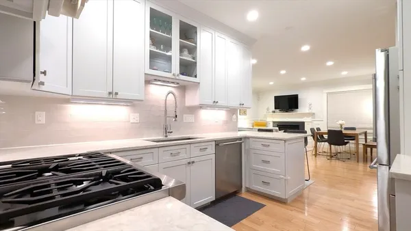 a kitchen with stainless steel appliances kitchen island granite countertop a sink and cabinets